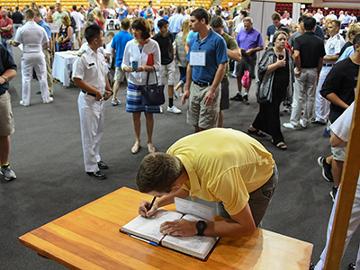 Image of a new cadet signing the Matriculation Book