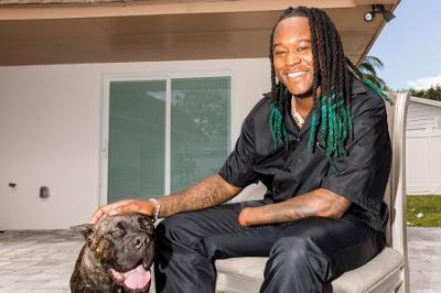 Shaquem Griffin poses with dog.