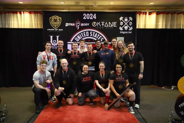 Col. Dan Barr ’74 and the VMI powerlifting club display their awards following the meet.
