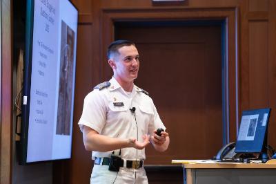 Ben Bowen ’26 explains the underlying driving principles of two of his favorite authors, Edgar Allen Poe and John Gardner, during his honors presentation in Scott Shipp Hall.