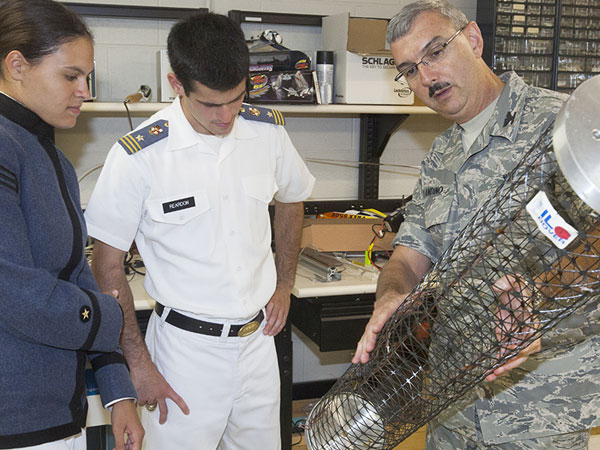 Image of Col. Joe Blandino with two cadets holding a light-weight deployable boom. 