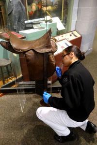 Caitryn Bell ’20 tests for arsenic on the saddle that Gen. Thomas J. “Stonewall” Jackson used on Little Sorrel.—Photo courtesy of Maj. Kevin Braun.