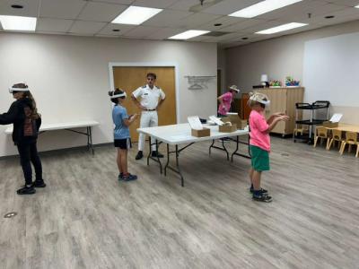 VMI cadet supervises as participants utilize VR equipment.