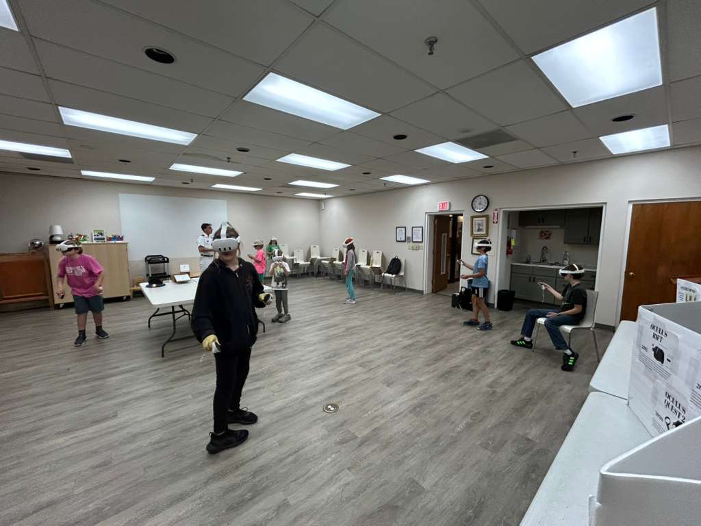 VMI cadet supervises as participants utilize VR equipment.