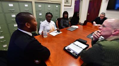 Three faculty members talk with three Aseshi University members