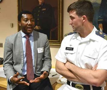Dr. Dekuwmini Mornah chats with Rives Worsham ’19 during the Business Leadership and Innovation Summit April 11.—VMI Photo by H. Lockwood McLaughlin 