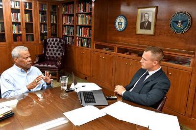 Al Hockaday sits at a table with Max Gallahan, VMI Class of 2020