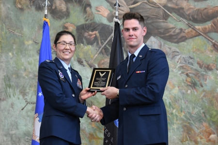 Air Force ROTC cadet receives an award from Col Scott, head of Det 880 ROTC program.