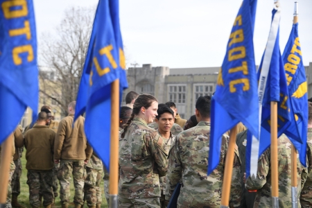 Air Force ROTC cadets wait near Detachment 880 flags for their turn on a helicopter flight over Virginia Military Institute.