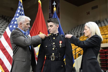 VMI graduating cadet receives rank insignia for the US Marine Corps during pin-on and commissioning events.