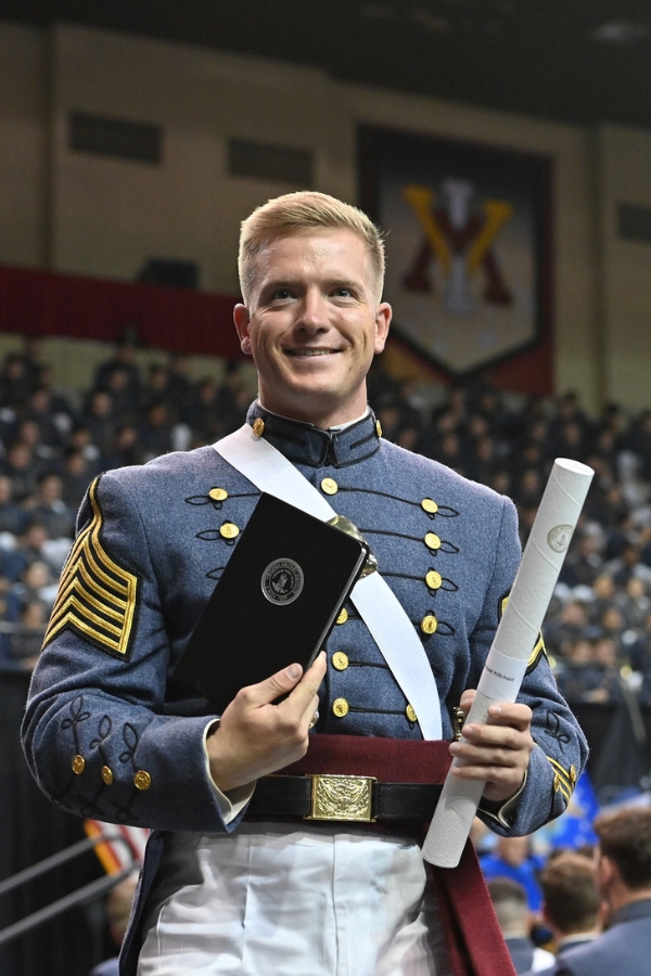 The 2024-25 Regimental Commander (RCO) Brian Pritchard stops to take a photo after receiving his VMI diploma.