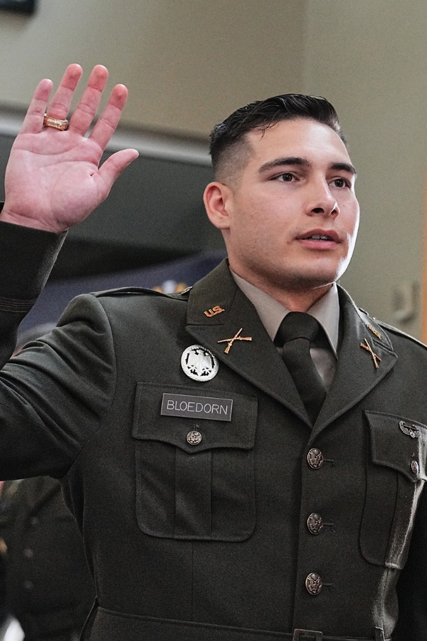 An Army ROTC cadet takes his first oath as he commissions as a 2nd Lieutenant.