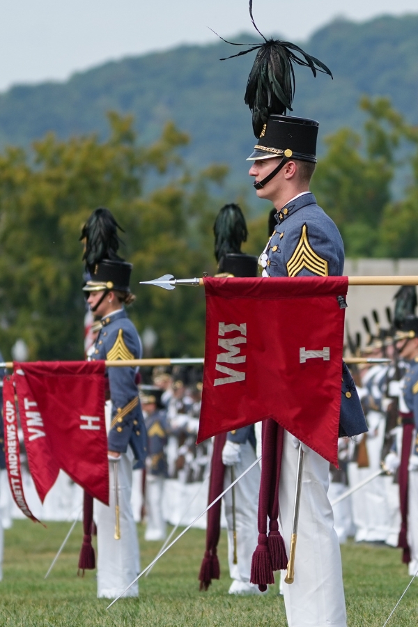 Cadets stand at attention with company flags during a parade at VMI.