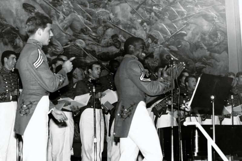 Cadets Mark A. Draper, Class of 1984 and David A. Twillie, Class of 1985 lead the audience in a song at a VMI Glee Club concert in Memorial Hall