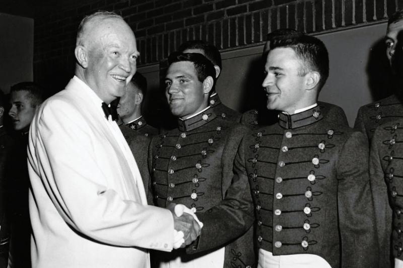 President Dwight D. Eisenhower shakes hands with Cadet Andrew J. Thacker, Class of 1961. The President met with Thacker and other members of the VMI Glee Club  after they entertained guests at the Federal Housing Administration Banquet in Washington, D.C. on June 18, 1959. VMI Archives