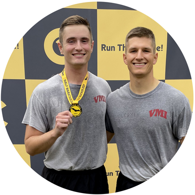 Marathon Running Club two cadets at a running event one holding a medal photo circle