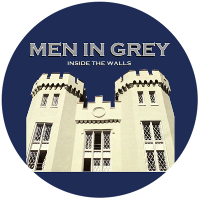 Men in Grey male acapella group logo circle showing VMI building