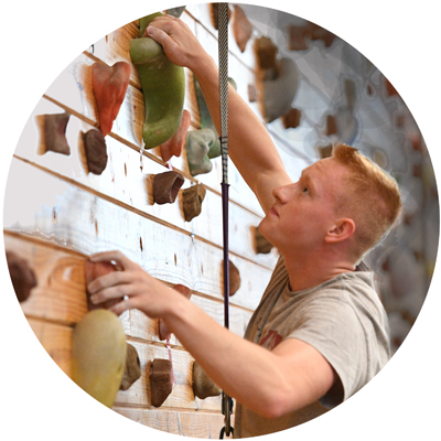 Rock Climbing Club cadet member climbing rock wall in gym photo circle
