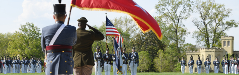 MG Wins '85, VMI superintendent, salutes Corps color guard during a parade.
