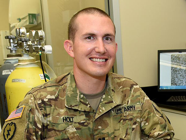 A man sitting in Army uniform