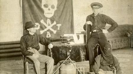 VMI Cadet secret society, the Molly Maguires. Skull and cross-bone banner in background. Includes Frank G. Doggett, Class of 1892; John B. Nicholson, Class of 1893.