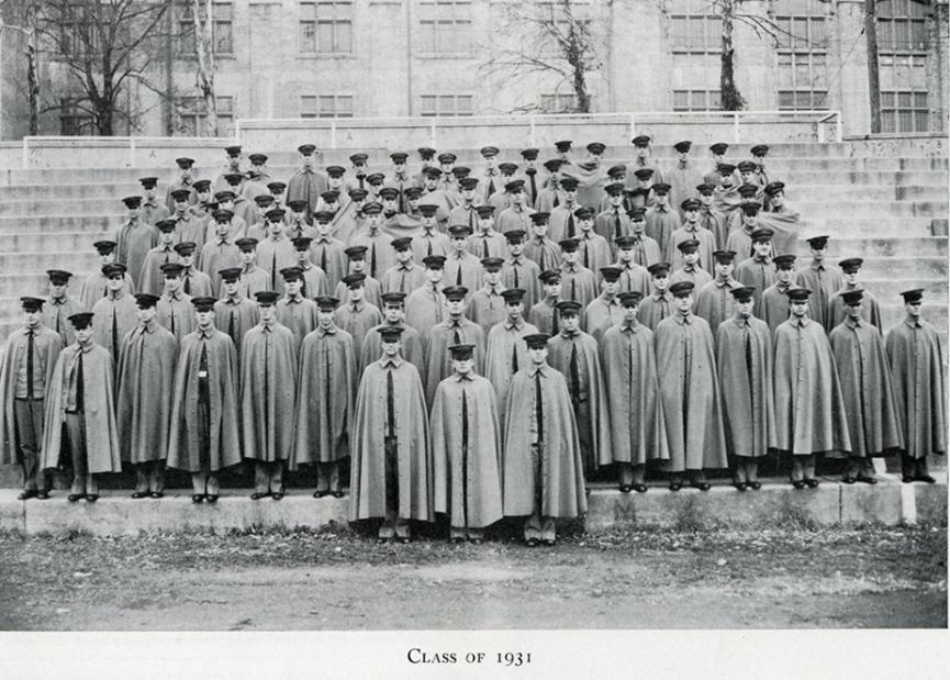 Class picture of the graduating class of 1931 on the steps of the parapet. They are dressed in grey blouse, cape, and garrison cover.