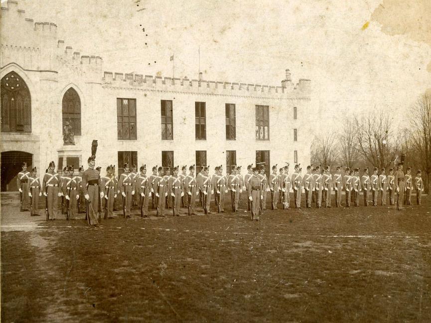 Three columns of cadets organized outside of barracks