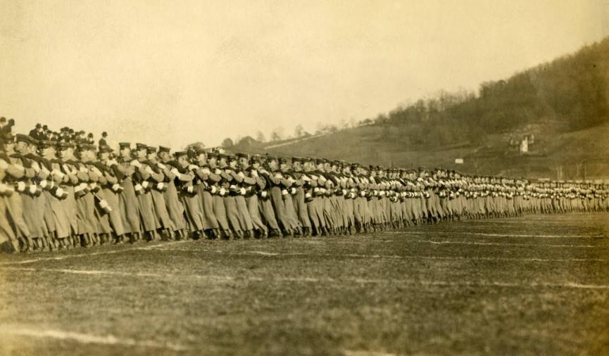 A line of cadets walking across the entirety of a field