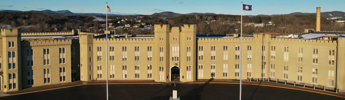 View of VMI barracks and buildings across parade ground with mountains in the distance