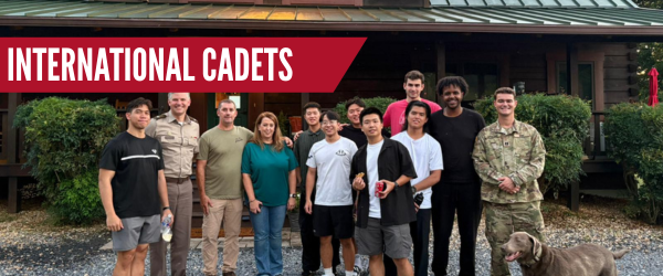 International cadets pose with global education staff and a hosting family.