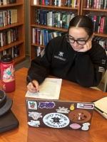 Delilah Martindale works on her research report.