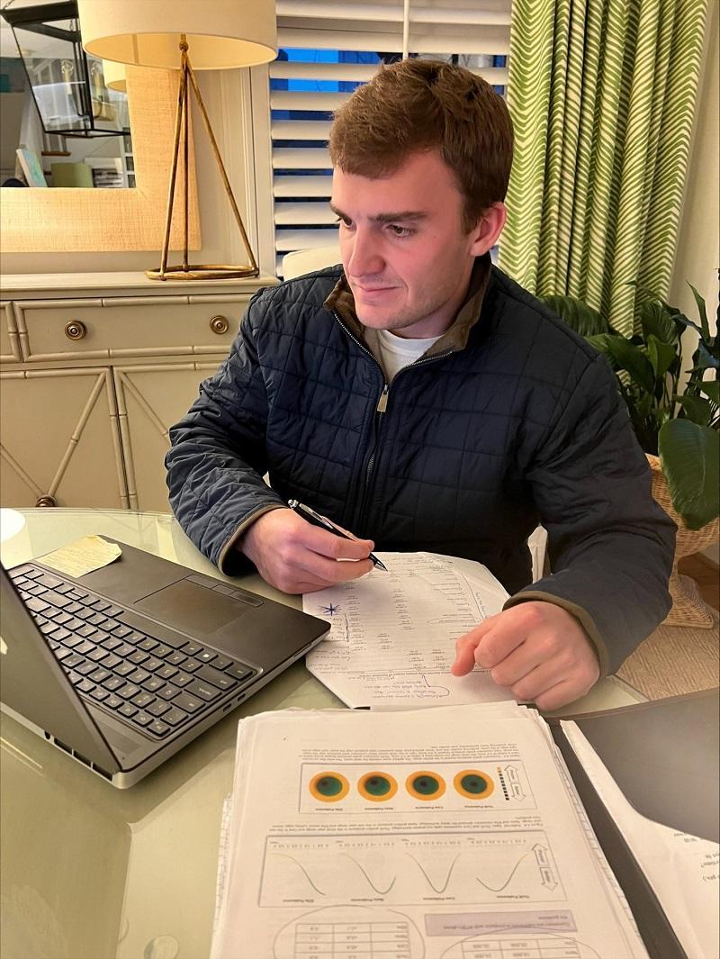 Harrison Williams works on his research at a laptop.