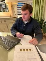 Harrison Williams works on his research at a laptop.