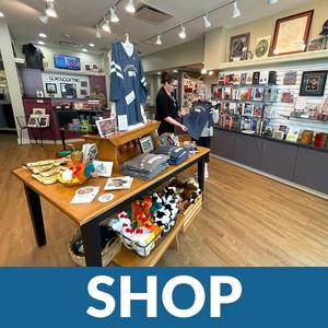 Photo of interior of museum shop with text reading SHOP.