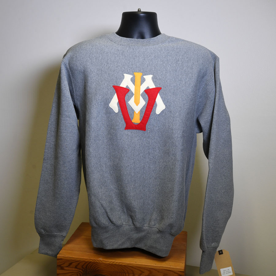 Felt cut out letters arranged on top of each other to create the VMI logo in 1878 on a light crew sweatshirt