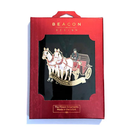 thin red box with clear opening shows a metal ornament with two horses pulling a open covered carriage with a driver in top hat