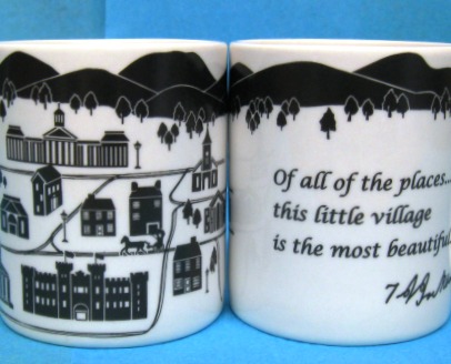 White 11 oz mug with a image of mountains and building of Lexington on one side and Quote of all the places... this little village is the most beautiful...