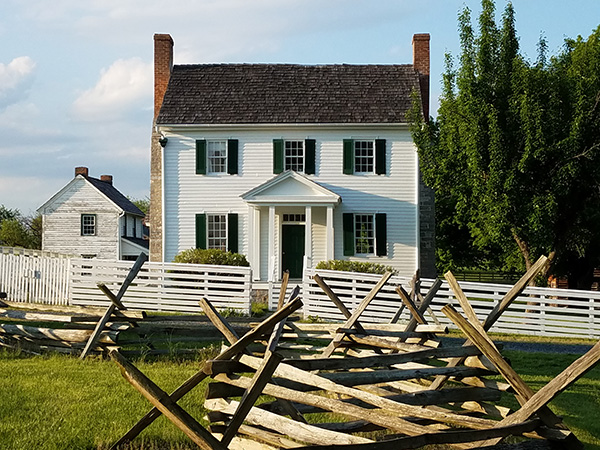 Photo of Bushong farmhouse with fence in foreground