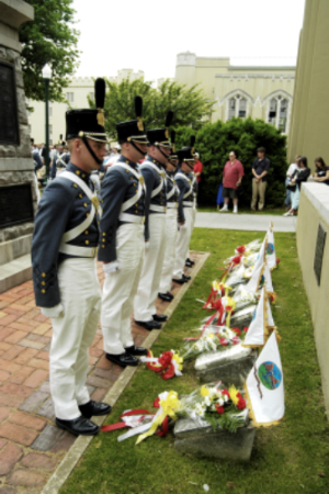 Photograph of VMI Cadets laying wreaths at the stones of the New Market fallen