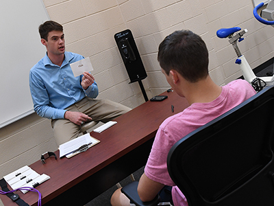 Sam Hudson '17 shows a flash card to a research subject.