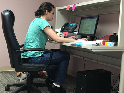 Samantha Alexander sitting at her desk