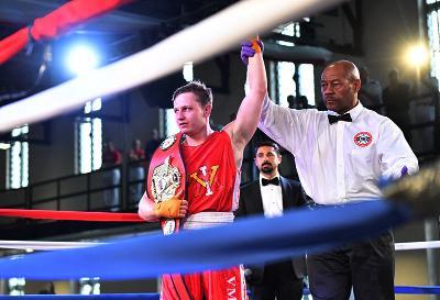 Nathan Miller stands with  the championship belt after winning his bout against University of Michigan’s Mike Henry during the final day of the USIBA National Championships March 23.