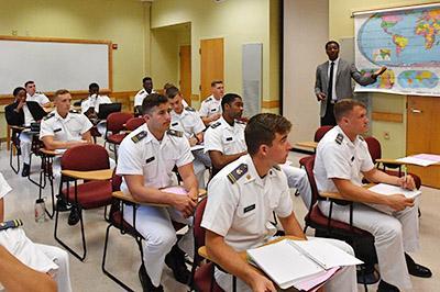 Professor Dee Mornah lectures in a classroom.