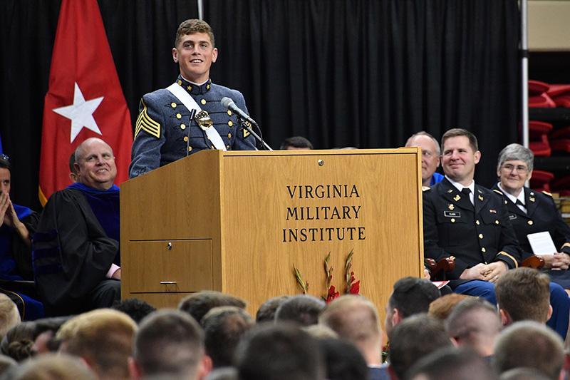 Valedictorian Drew Borinstein speaks at the podium