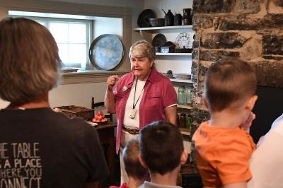 Tamara Teaff, a volunteer at the Stonewall Jackson House, leads visitors through Jackson’s kitchen. – VMI File Photo by H. Lockwood McLaughlin. 