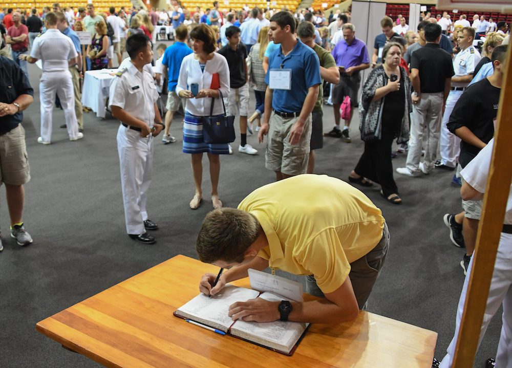 Image of a new cadet signing the Matriculation Book