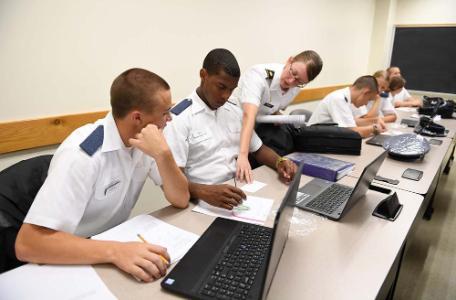 Maj. Amy Givler assists Alec Westall ’20 and Tyain Smith ’20, students in her precalculus class, with a graphing activity using Wikki Stix. – VMI Photo by John Robertson IV.