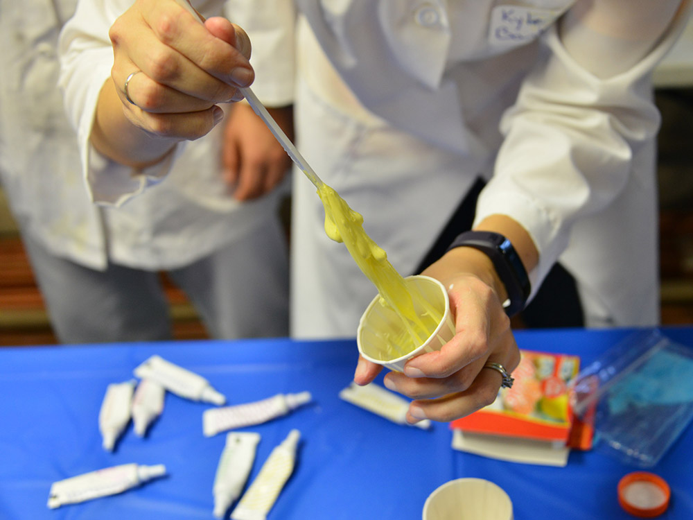 A hands-on activity to make silly putty led by Maj. Kyle Bantz gives participating children an introduction to polymer chemistry.