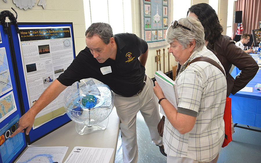 Col. Greg Topasna talks astronomy with science fair participants.