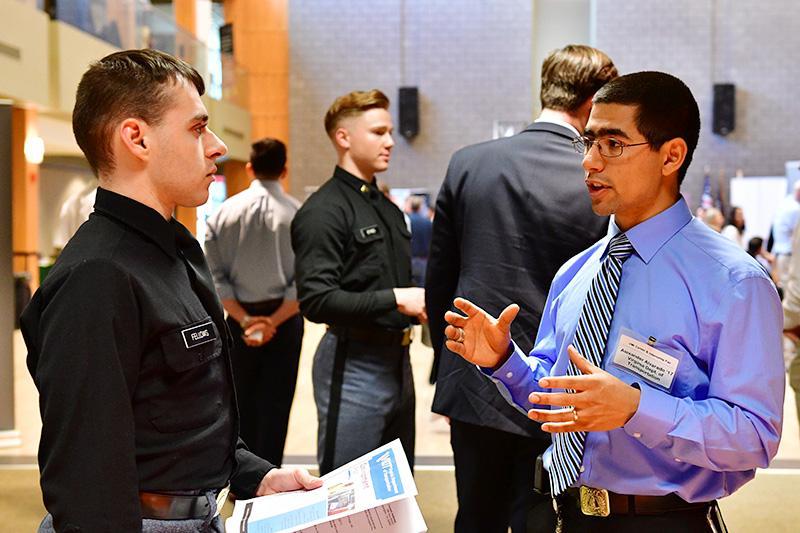 Alexander Alvarado speaks to Holden Fellows '20 at the VMI career fair.